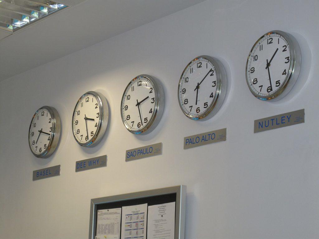 row of clocks displaying time around the world