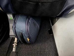 Halfday Roamer Backpack under an airplane seat