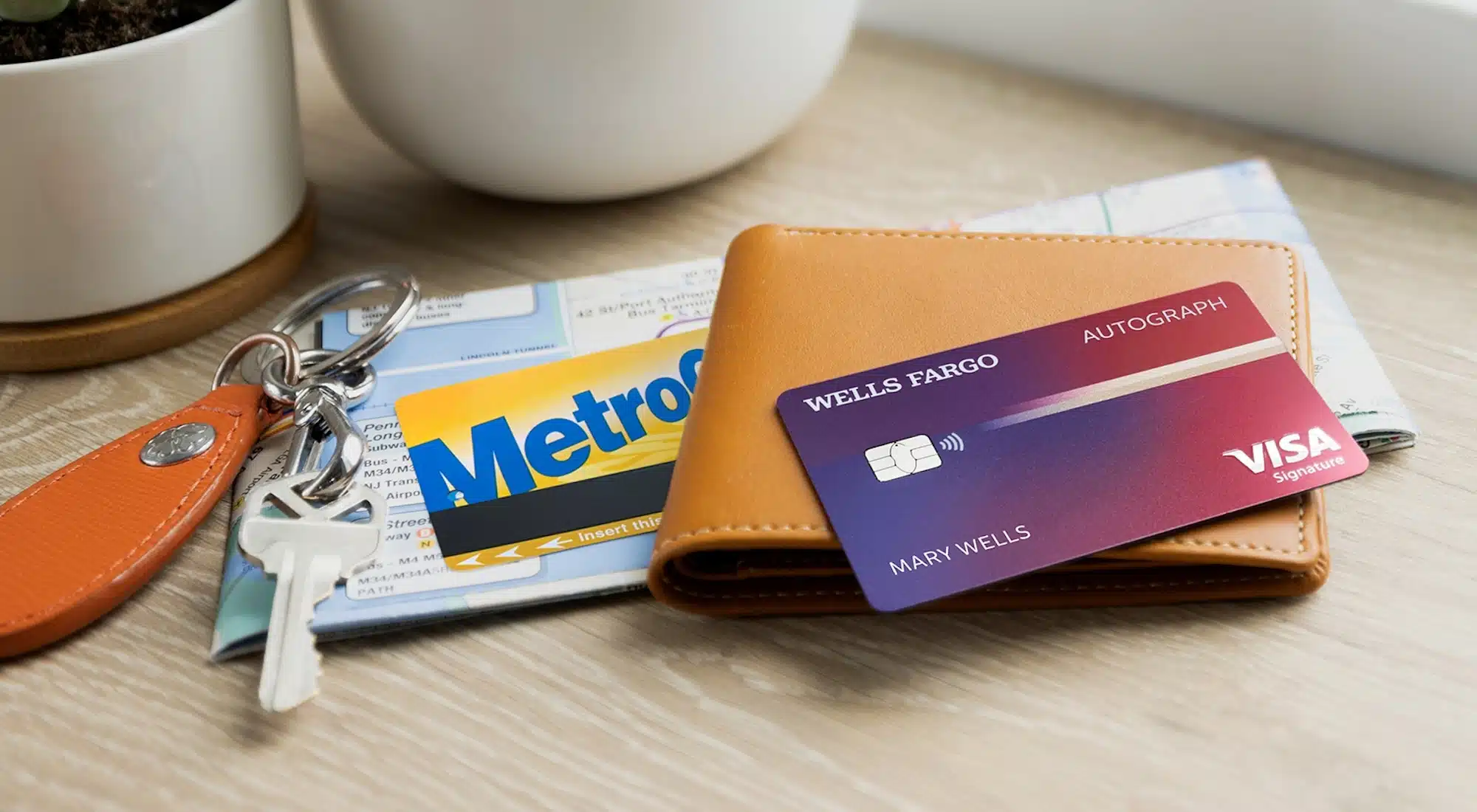 Wells Fargo Autograph Visa Card on a wallet with a map and keys