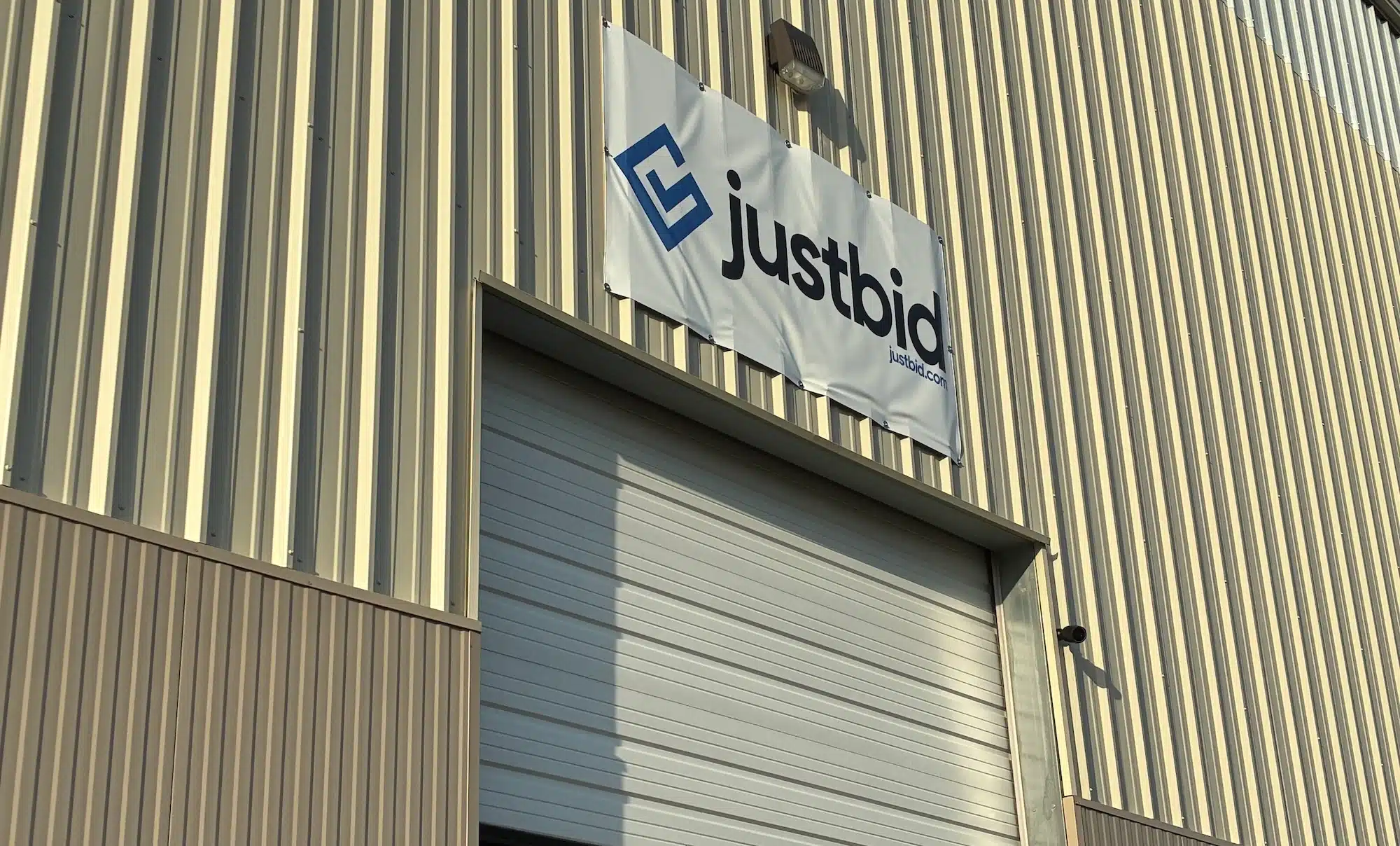 JustBid logo on a warehouse