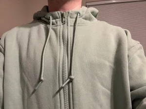 wearing a Comfrt Airplane Zip Hoodie