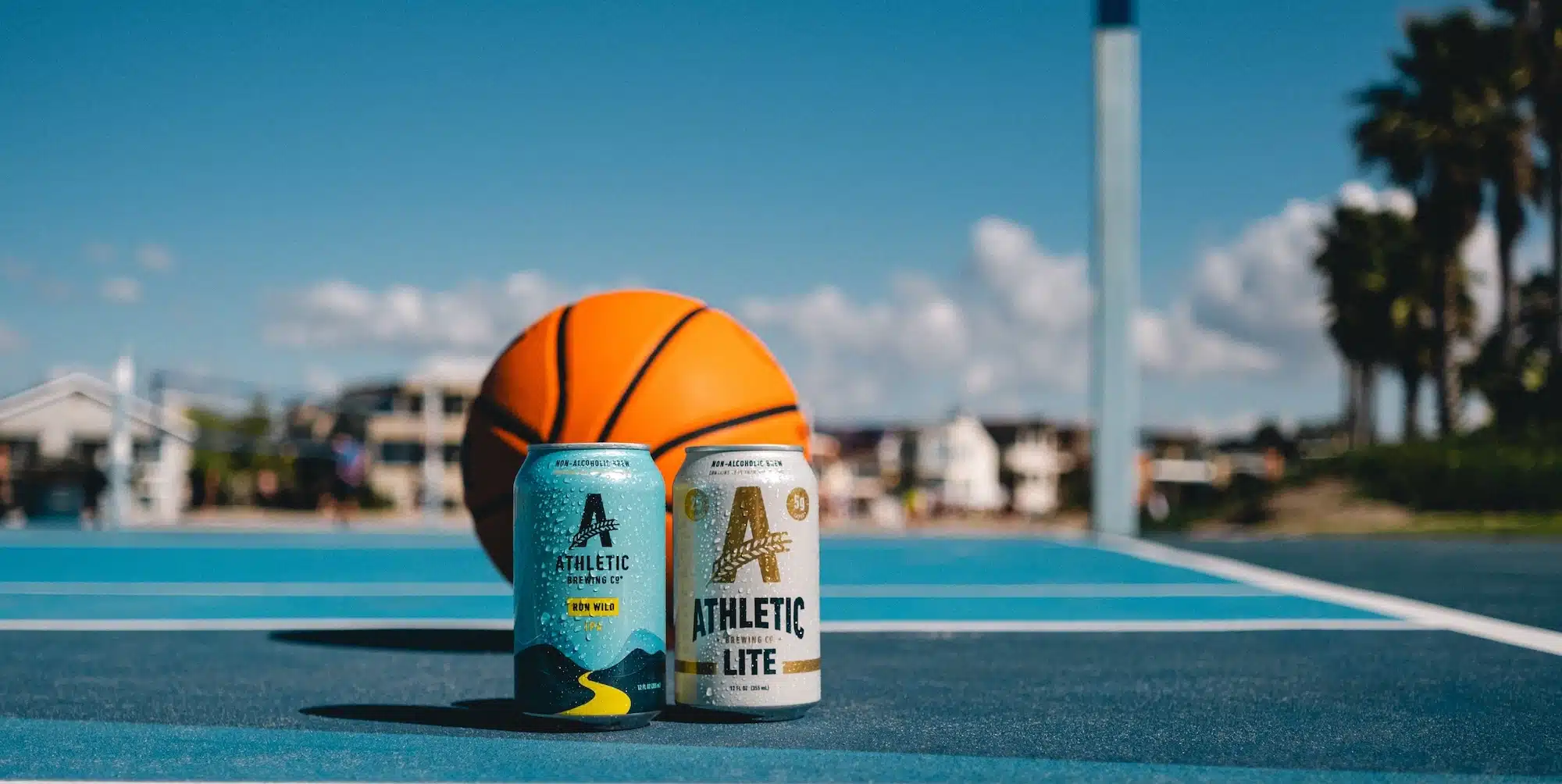 Athletic Brewing beers and a basketball on a court