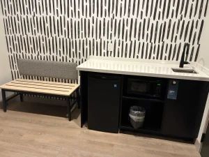 sink, mini-fridge / microwave, and luggage stool at a room in the Atwell Suites Kansas City Airport