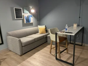 living room area in a suite at Atwell Suites Kansas City Airport